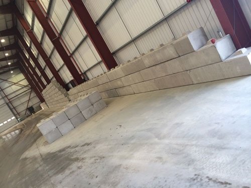 Duo interlocking block dividing wall inside an empty storage building