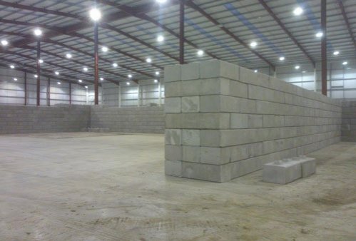 Freestanding Duo block bay under construction in a large empty warehouse