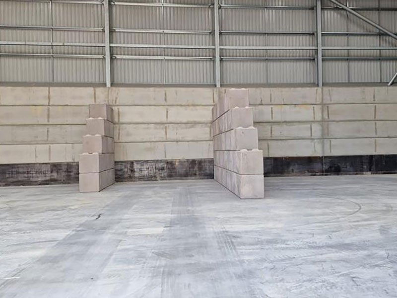 Legato blocks stacked in columns against an internal warehouse wall