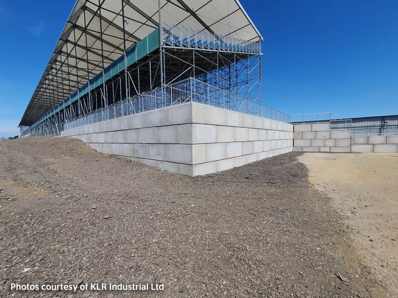 Legato interlocking blocks forming a plain retaining wall beside a grandstand