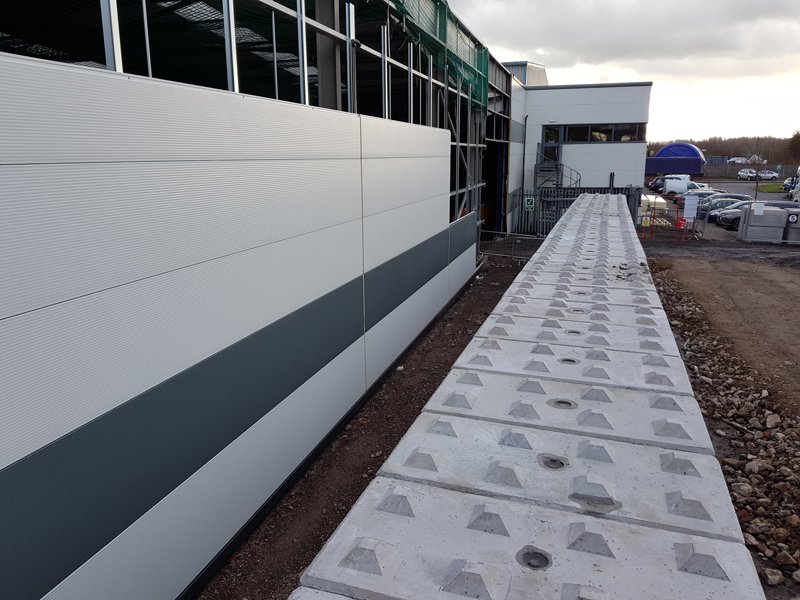 Legato blocks laid flat in a row alongside a newly clad commercial unit