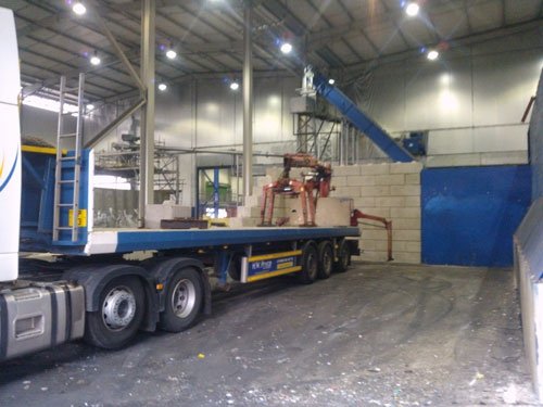 Lorry-mounted crane offloading Duo blocks inside an industrial building
