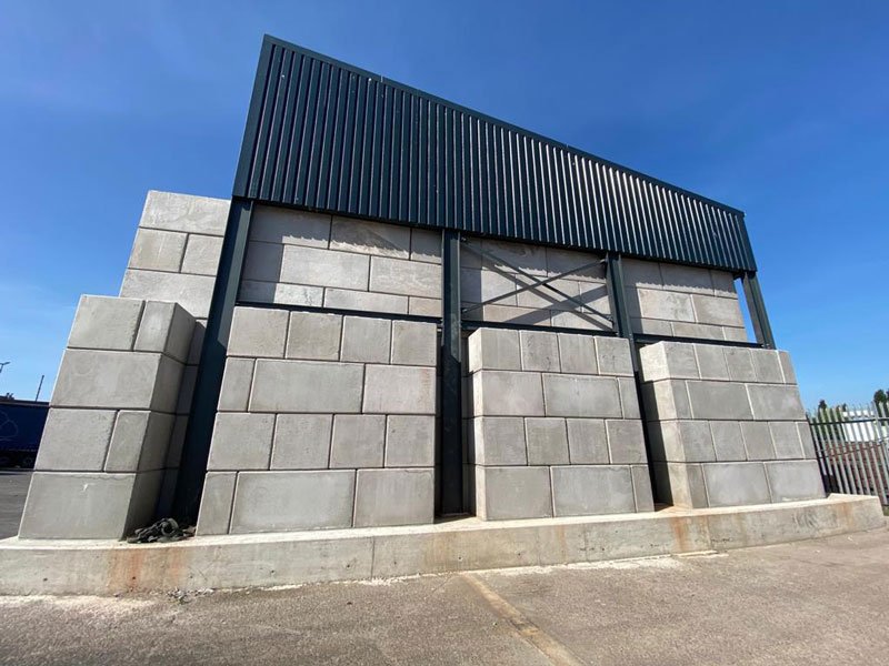 Legato block walls carrying a steel roof structure over an open bay