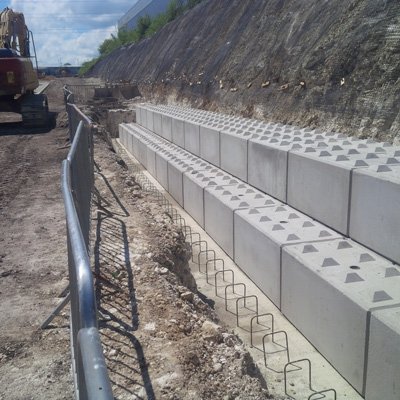 Long run of Legato blocks laid shear keys up along a cut slope