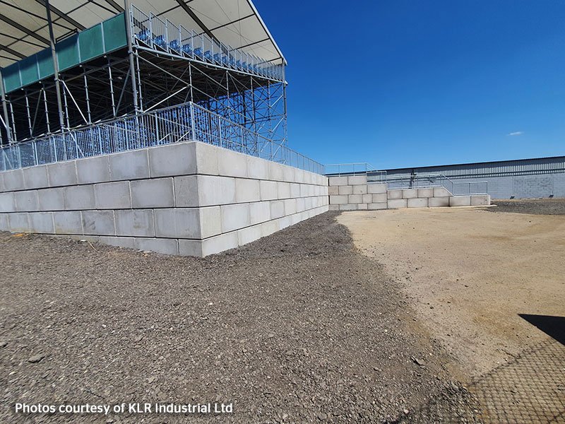 Legato interlocking blocks forming a retaining wall beneath a grandstand