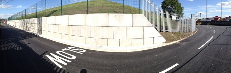 Curved Legato interlocking block retaining wall following a bend in a road