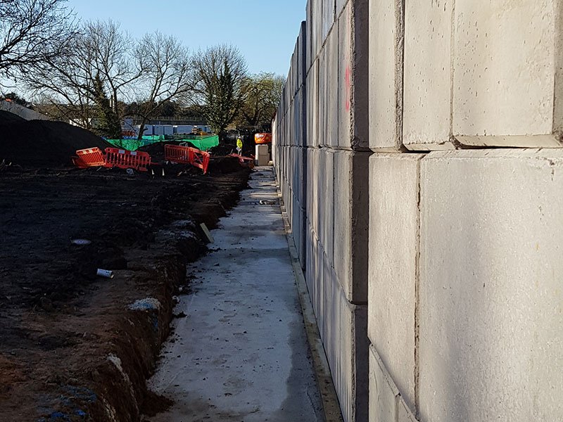 Legato block retaining wall beside freshly excavated ground on a construction site