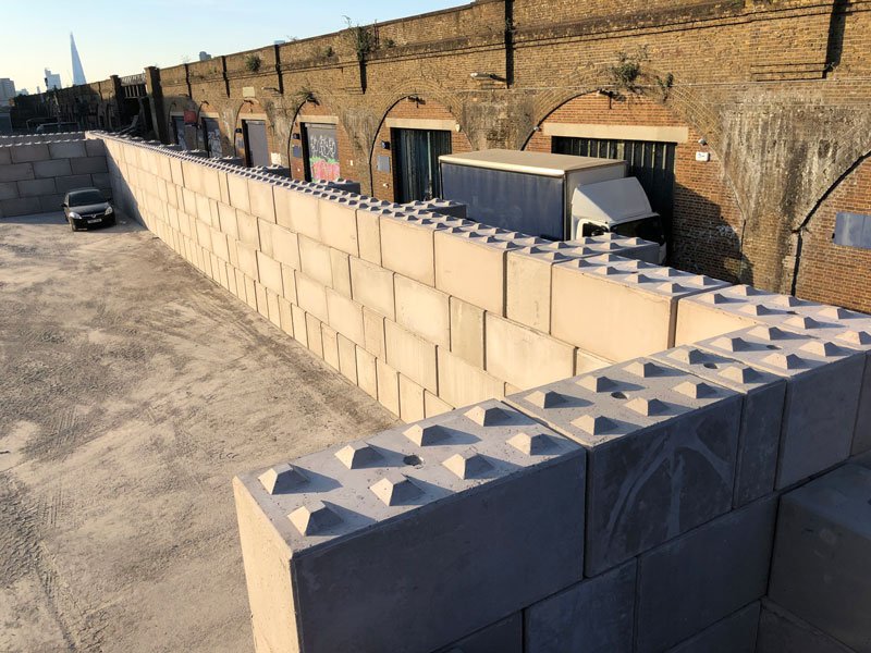 Legato wall built against railway arches with dark blocks laid shear keys up