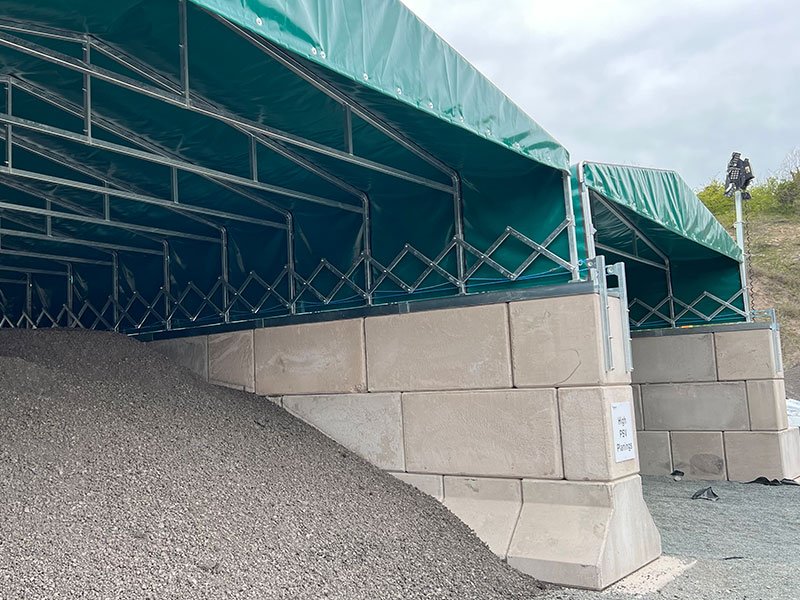 Legato block bay walls supporting a green tensioned fabric canopy