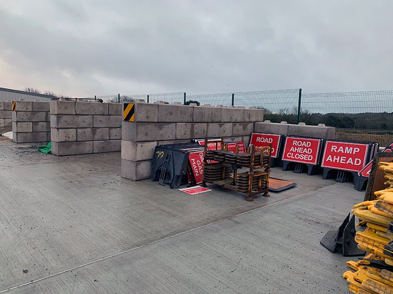 Interlocking block storage bays holding road signs at a highways depot