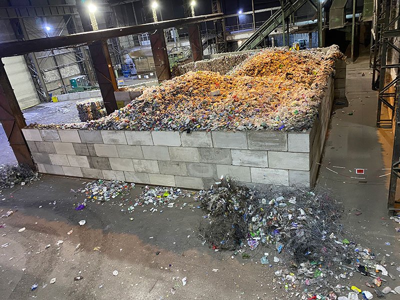 Segregation bay of interlocking blocks holding shredded waste at a recycling plant