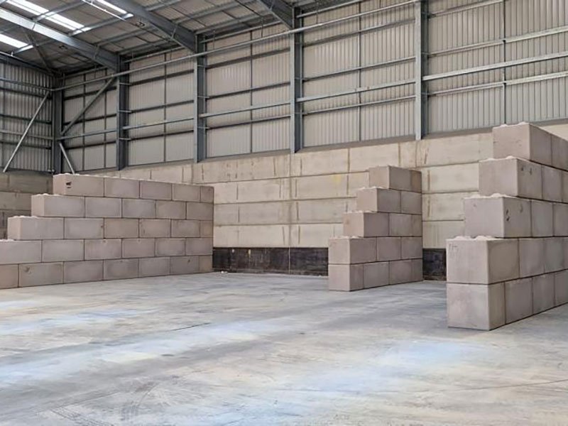 Stepped Legato block walls forming empty storage bays inside a shed