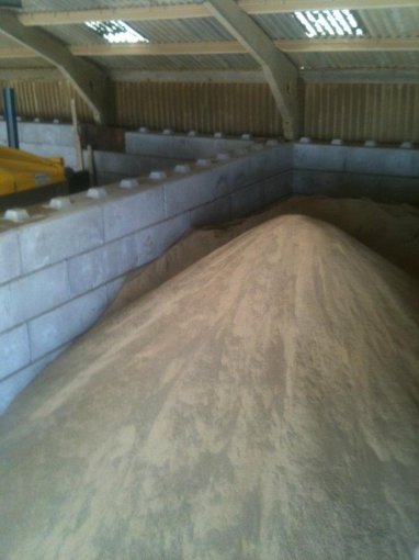 Salt heaped in a Duo block storage bay beneath a curved barn roof