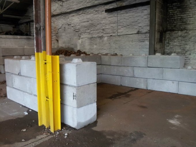 Duo blocks forming a low storage bay wall inside an existing barn