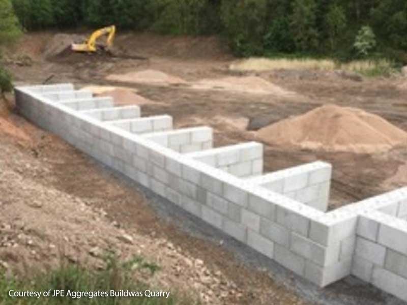Interlocking block storage bays holding aggregate stockpiles at a quarry