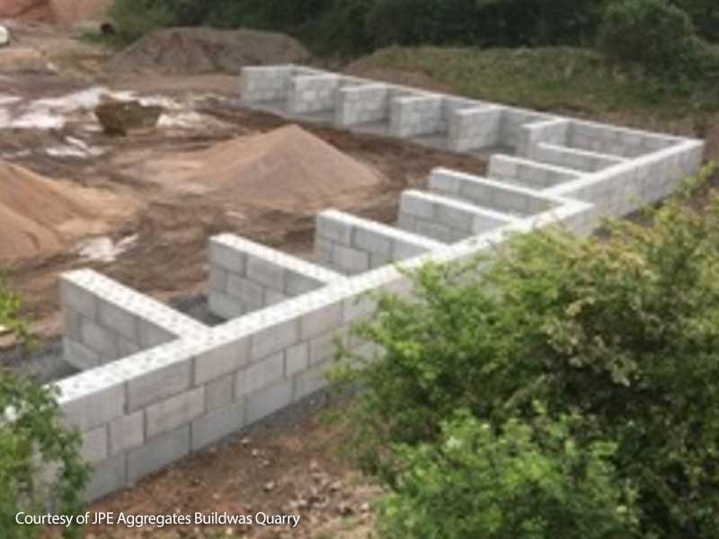 Row of interlocking block bays with dividing walls at a working quarry