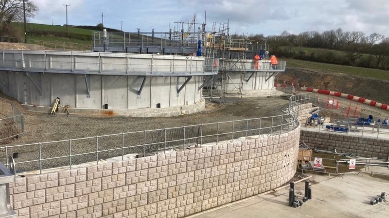 A curved Retainer-Rock retaining wall and precast concrete tanks at Cardigan wastewater treatment works